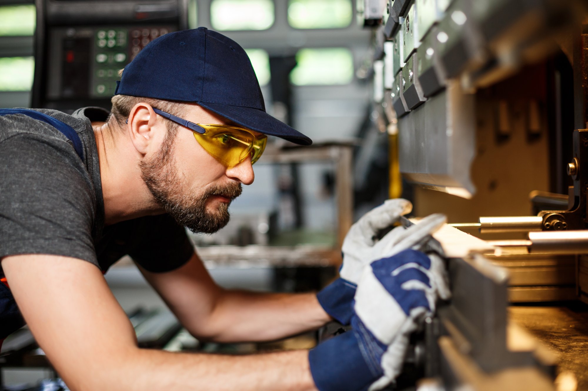 portrait-worker-near-metalworking-machine